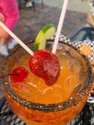 Mango margarita with a mango lollipop