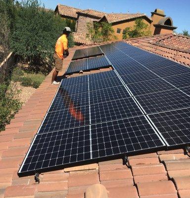 One of our team-members next to a new residential solar system array!