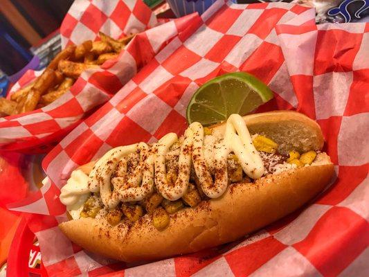 The Elote Dog: roasted corn, cotija cheese, mayo, chipotle powder, lime wedge.