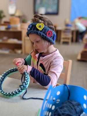 Practical life skills: knitting with a loom.