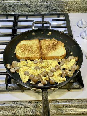 Homemade French toast, eggs and sausage.