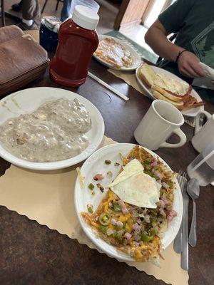 Biscuits and gravy and loaded hash browns with an egg