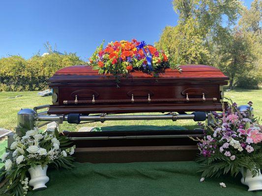 The flowers on top of the casket are from Carol's Corner.