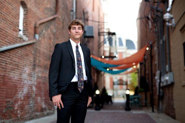 Senior photos, senior boy in suit and tie, senior portraits in downtown alley