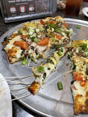 Gourmet Veggie Pizza: Artichoke hearts, zucchini, spinach, mushrooms, tomatoes, garlic, red & green onions on our Creamy Garlic Sauce