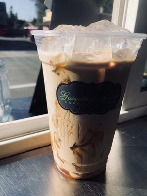 Iced americano with cream and honey drizzle on top. Customers recommendation