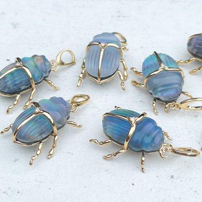 Hand Carved Scarab charm pendants made by Maura Green, fine jewelry designer.