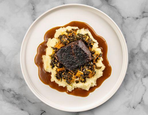 Elegant beef short ribs braised with sweet tea, and paired with creamy mashed potatoes and roasted field vegetables from YardBird