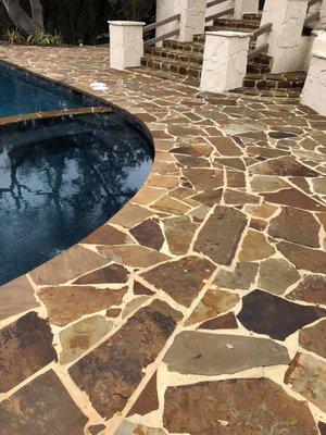 Flagstone pool surround after cleaning and enhancing