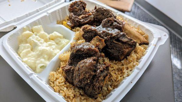 Beef rib plate with egg fried rice and potato salad.