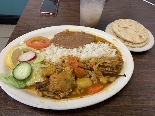 Salvadoran chicken stew, with pupusa.