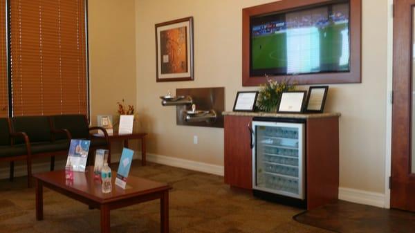 Big waiting room with tv and complimentary water while you wait