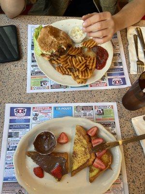 Short stack of french toast with nutella and strawberries, and a california burger with cajun fries