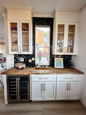 Custom Art Deco-Inspired Bar
Elegant glass cabinets, wine cooler, and a bold Art Deco-inspired backsplash and chopping block countertop.