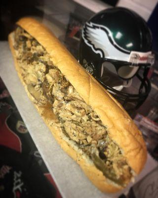 Our 12 hour marinated chicken cheesesteak with mushrooms, onions, and peppers.