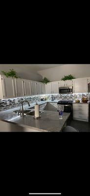 Refinished cabinets, backsplash, under cabinet lighting.