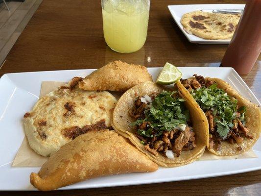 Platillo Los Compadres: 1 Steak and Cheese Pupusa, 2 Al Pastor Tacos (Marinated Pork), 2  Empanadas (1 ground beef and potato, 1 potato)