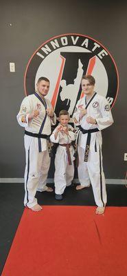 Ryland with Senior Master Turner and Mr Walls after moving up to brown belt.