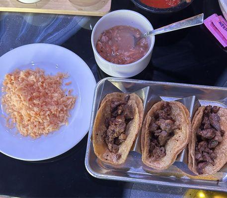 Steak street tacos with beans and rice and a drink on the lunch menu for $ 9.99 .