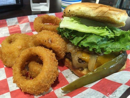 Cheese burger with grilled mushrooms and onions with onion rings and pickle