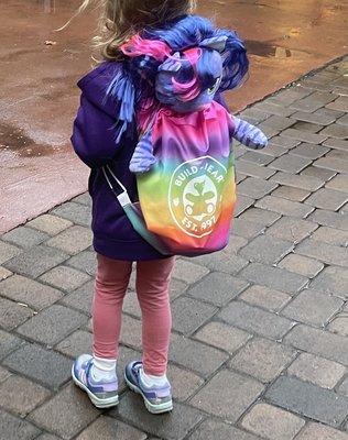 Beautiful bear now named Lavender in her rainbow backpack.