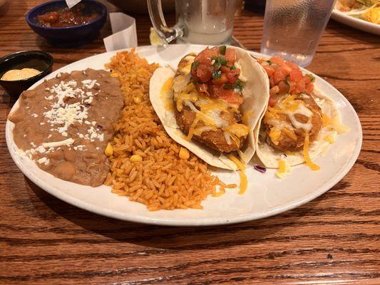 Fish tacos (2) along with rice and beans - nicely prepared