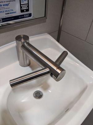 This fancy faucet had the hand dryer built in!  Those side arms are dryers.