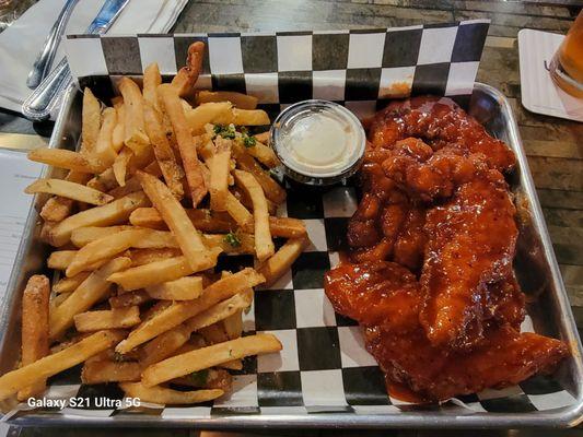 French fries and honey Sriracha chicken fingers