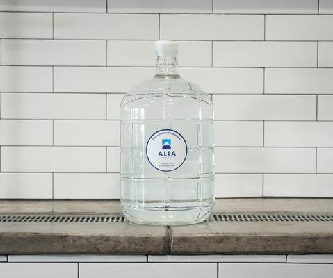 3-gallon Italian glass bottle filled with ultra-purified water.