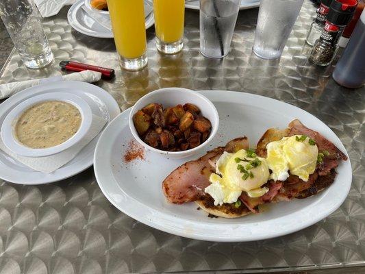 classic eggs benedict with a side of potatoes and sausage gravy