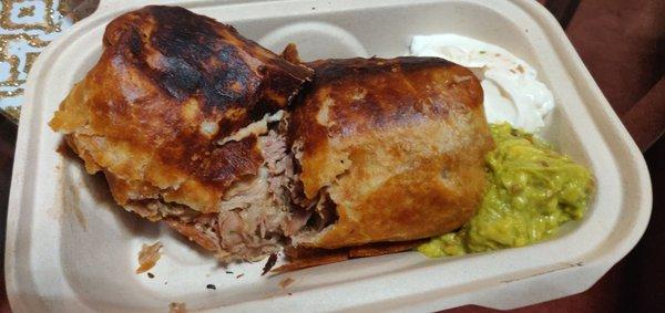 Fried Chimichanga / burrito (pork). Sour cream and guac