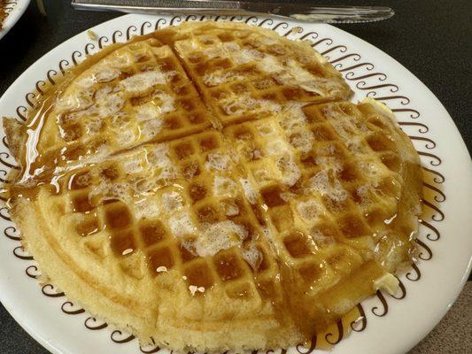 Waffle in butter and maple syrup