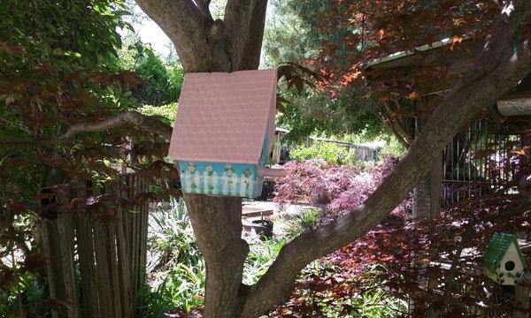 Cute birdhouses are among the garden accessories