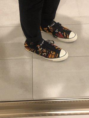 A customer wearing Converse Chuck Taylor All-Star 70s Ox Undefeated Varsity Jacket.