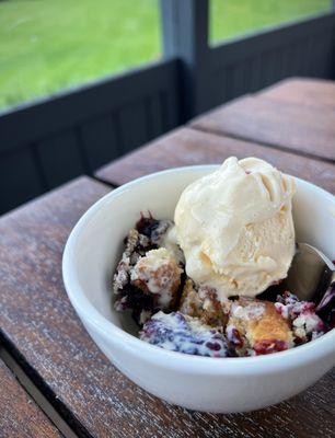 Wild berry cobbler with vanilla ice cream.