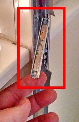 The shower door magnet which was mounted to the shower frame, that kept the shower door shut, broke off.