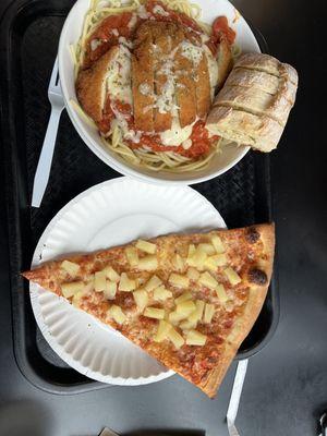 Chicken parmigiana and slice of pizza with pineapple