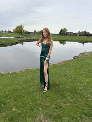 Girl in green prom dress by pond