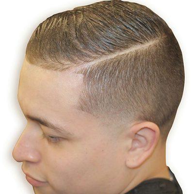 Bald taper on side with hard part. Comb over on top