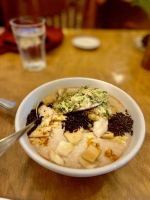 Market Fish - steamed mahi with garlic, ginger, scallion and soy in roasted bone congee with chili oil and wild rice