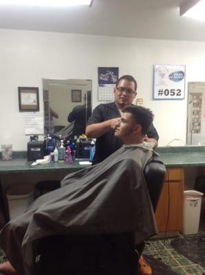 Another great barber, Francisco creating a masterpiece out of his customer's hair.