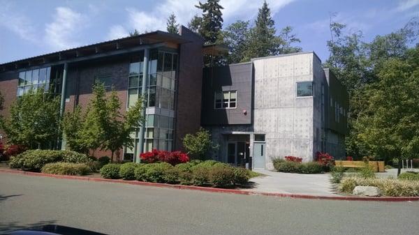 Back entrance of the building, near the staff parking lot.