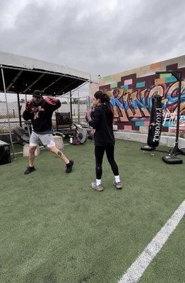 Coach Carlos instructing on how to throw a left hook