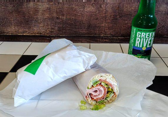 Neatly wrapped sub and a unique soda