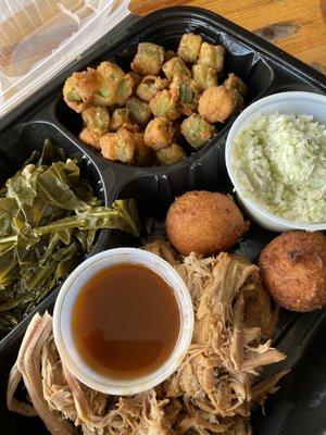 Barbecue plate with fried okra, collards and hush puppies and slaw