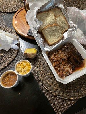 Two Meat Combo with Ribs and Chopped Pork. Paired with baked beans and Mac and cheese along with 4 slices of bread. Pound cake on the side.