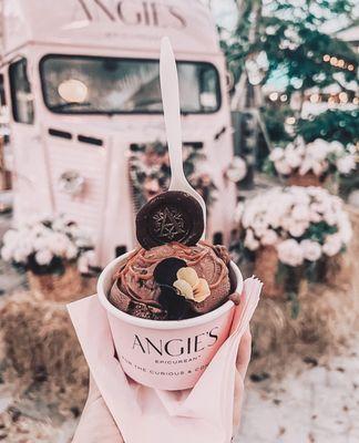 Our chocolate ice cream topped with caramel sauce, edible flowers, and The Angie's Stamp