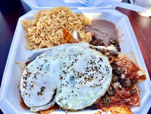 Chilaquiles with eggs over medium, carne asada, and red sauce to go.