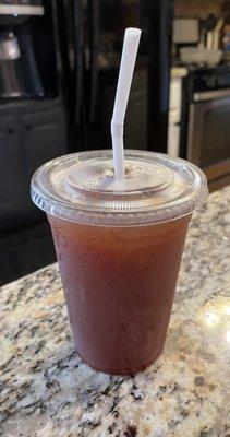 An iced tea, complete with a bending straw