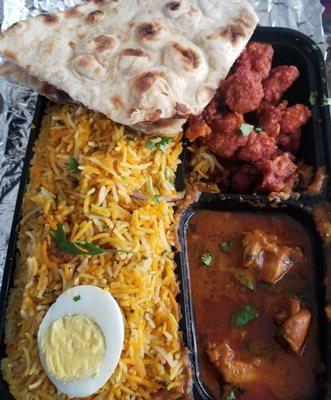 Chicken dum biryani platter with chicken appetizer, chicken curry, half naan